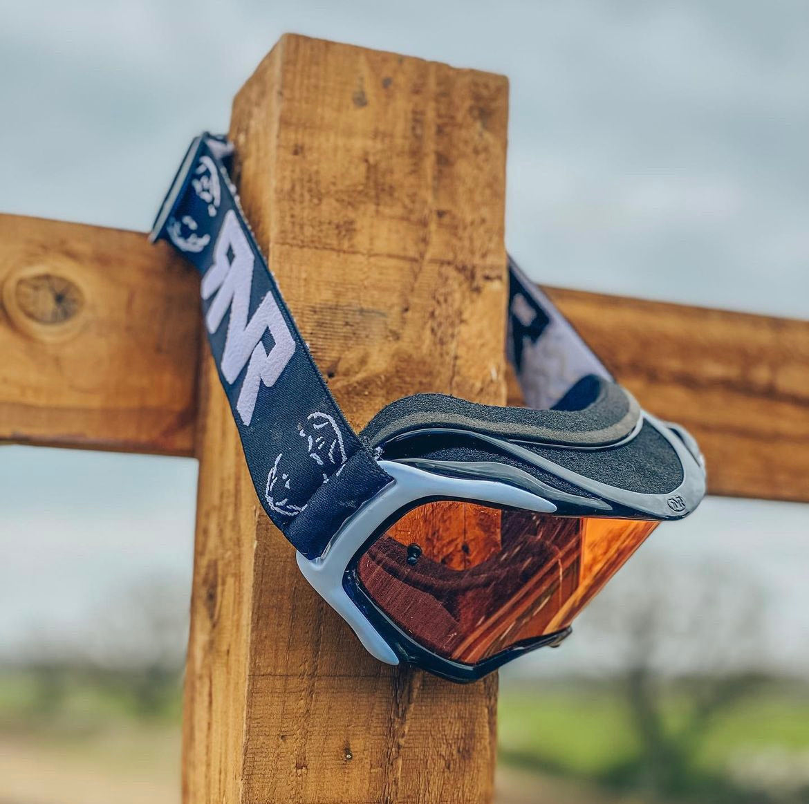 Motocross goggles on fence